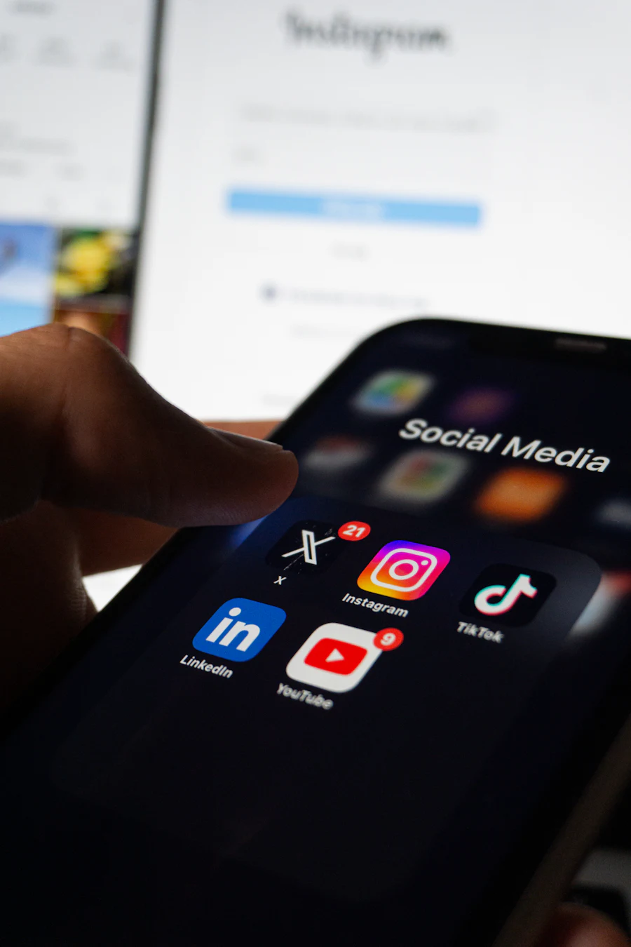 A phone showing a folder of social media apps