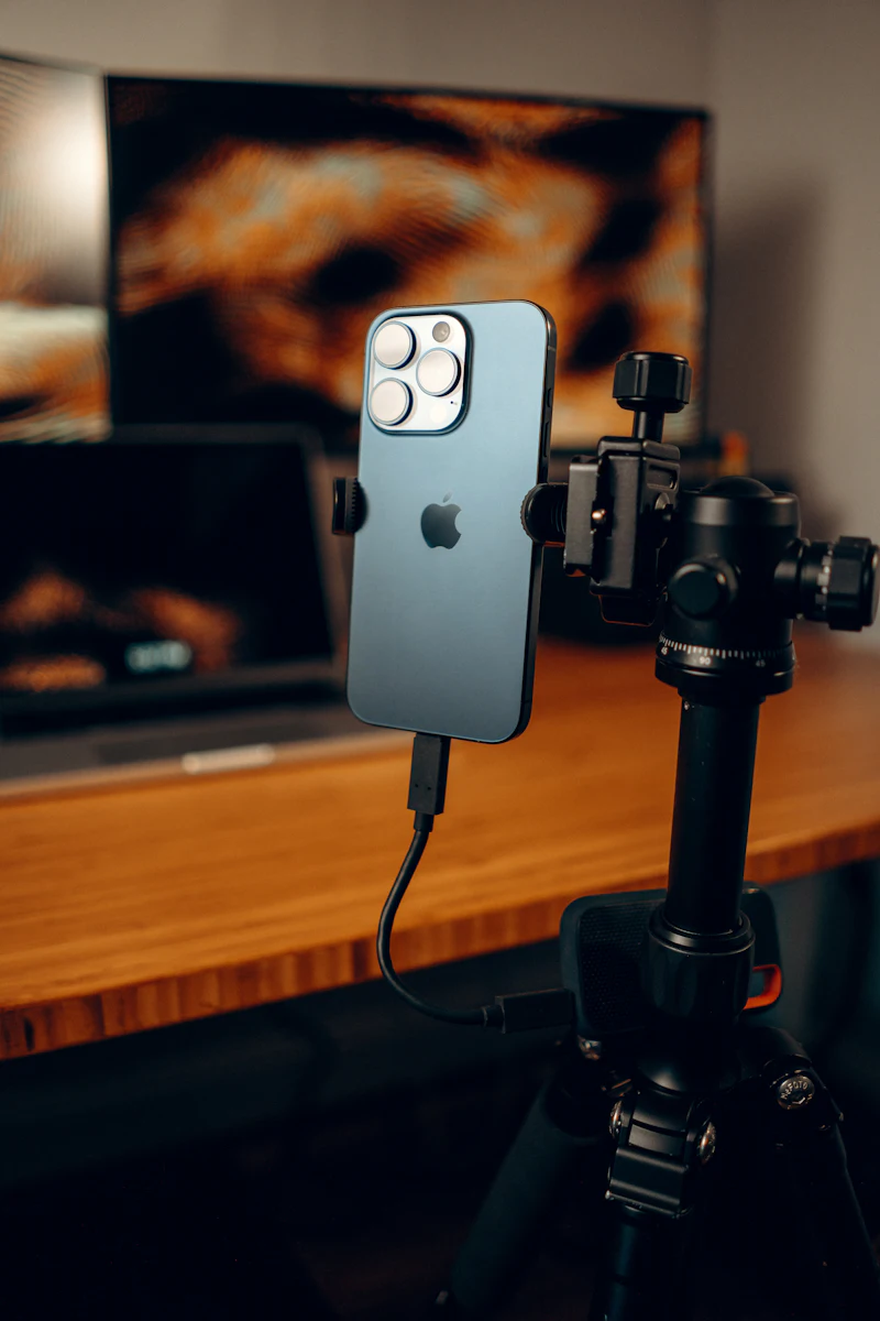 A smartphone mounted on a tripod, ready to record