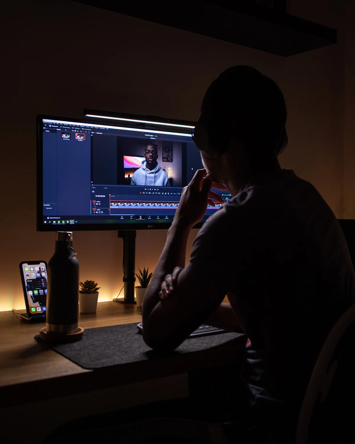 A creator reviewing a draft on a monitor at night